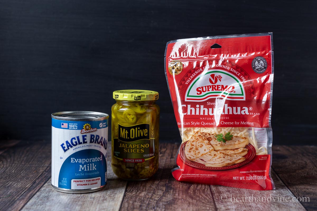 Queso dip ingredients including jalapeno slices, chichuahua cheese, and evaporated milk.