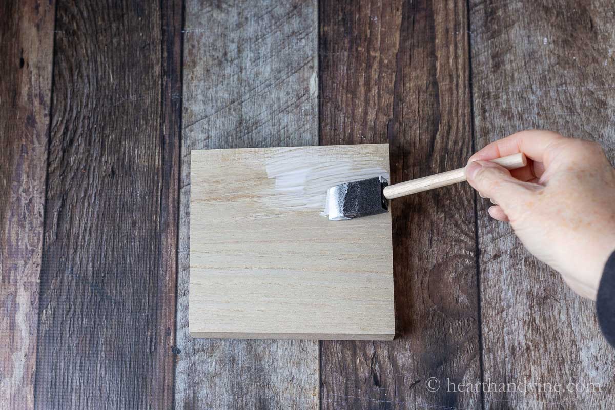 Brushing glue on wood block.