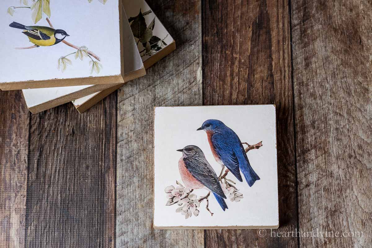 Blue birds print on a wood block.