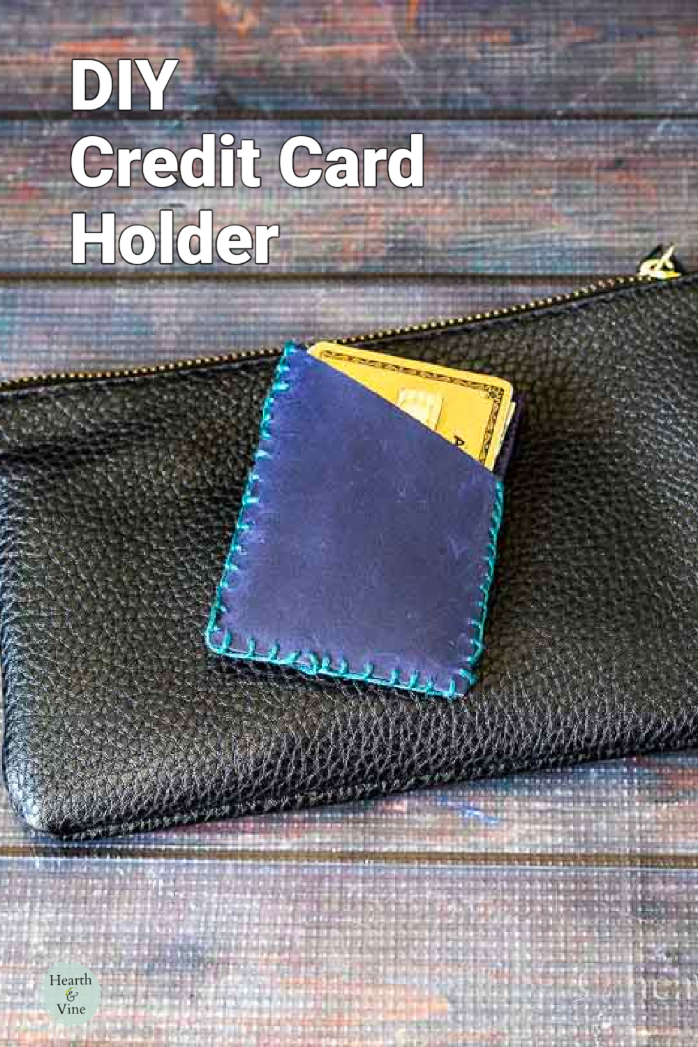 Small leather credit card holder on top of a black clutch.