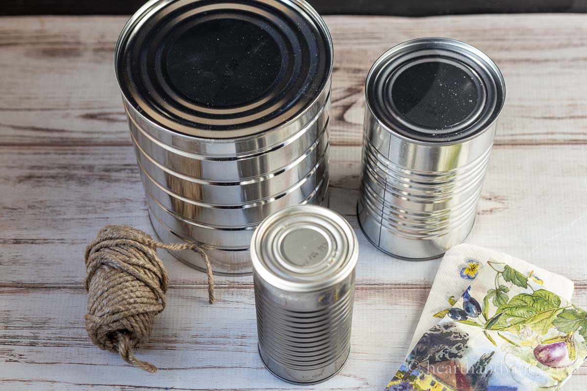 Three tin cans, napkins and twine.