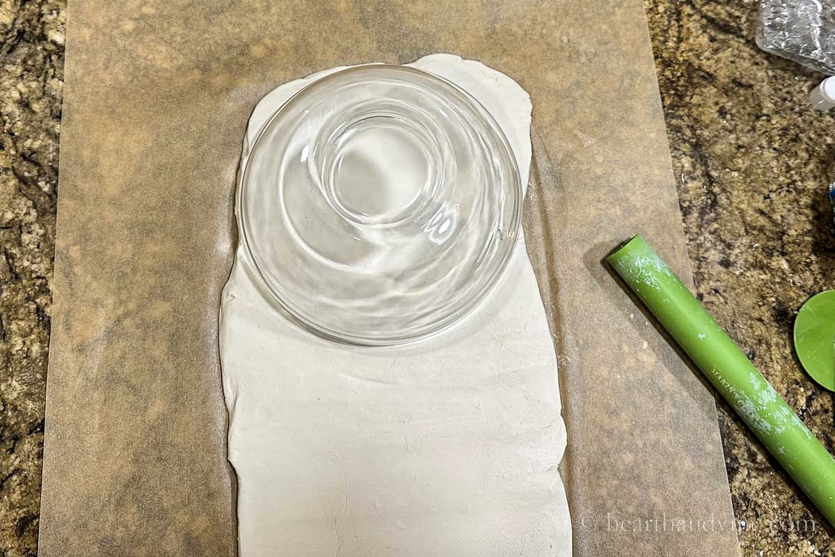 A small glass bowl used to cut a rounded shape to the top of the clay.