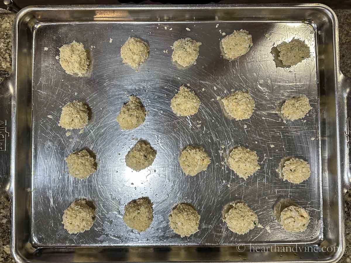 Raw crab balls on a baking sheet.