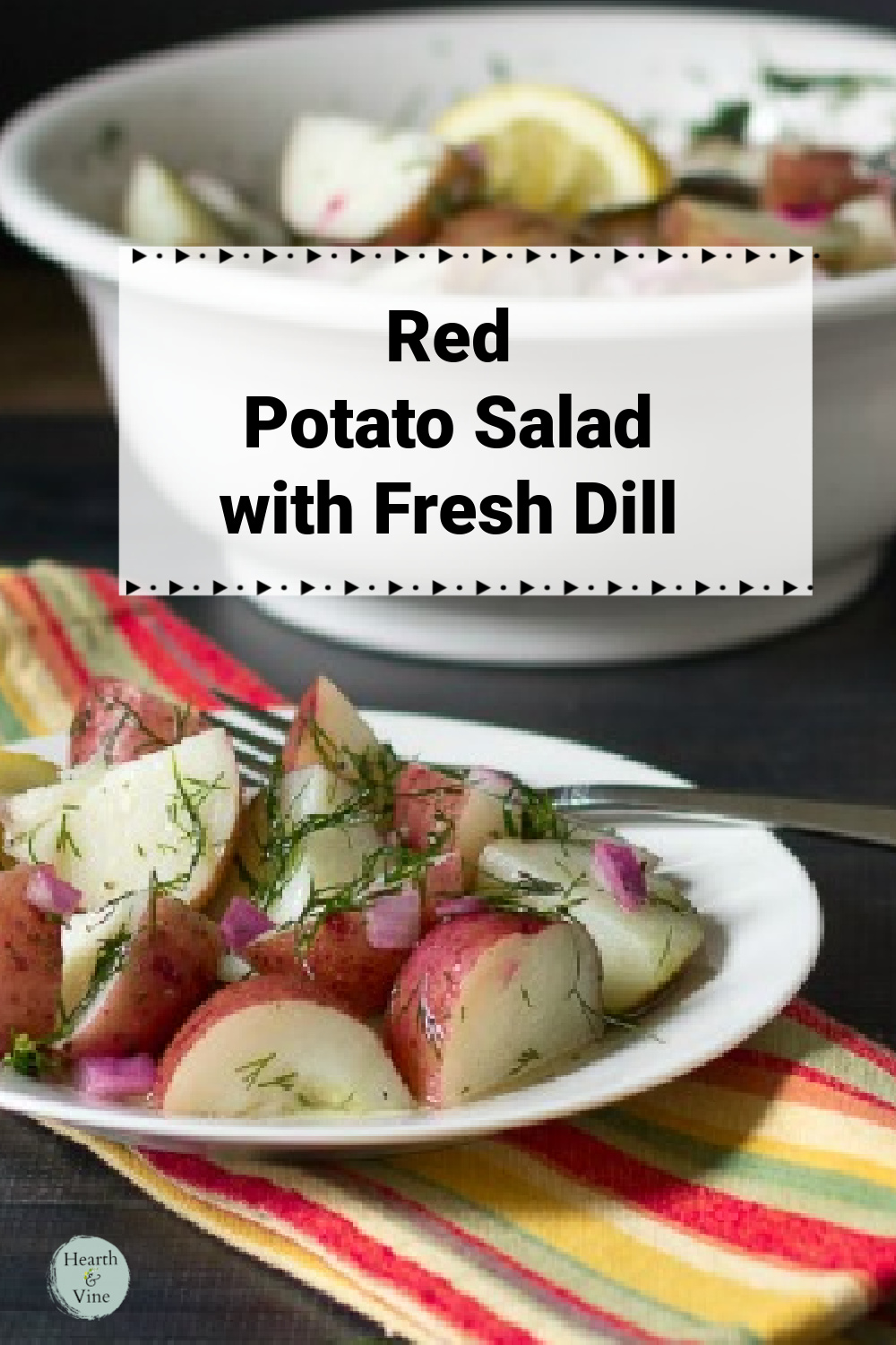 A serving plate of red potato salad with dill and red onions.