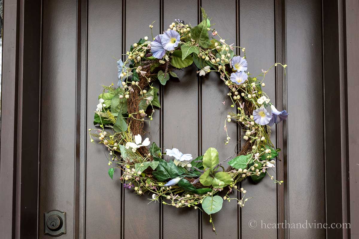 Spring garland wreath hanging on the front door.