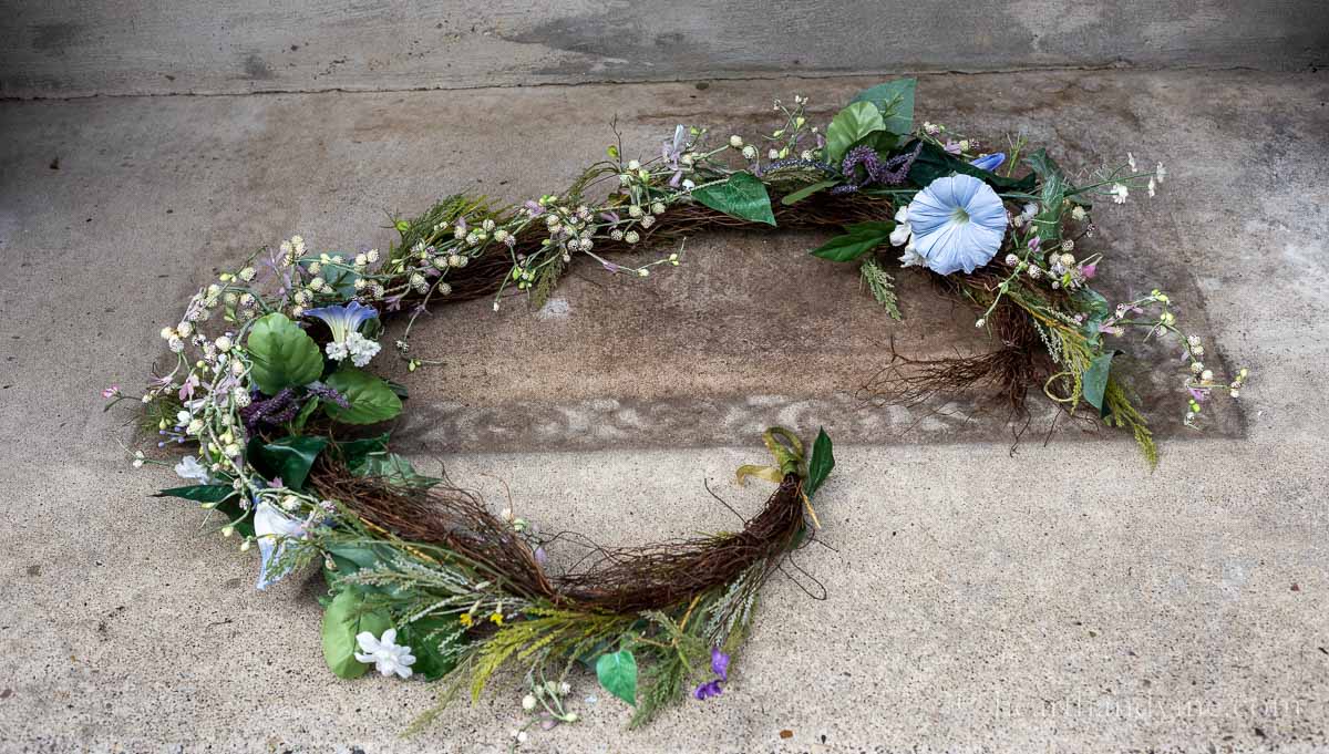 A spring floral garland with blue morning glories and lavender berries.