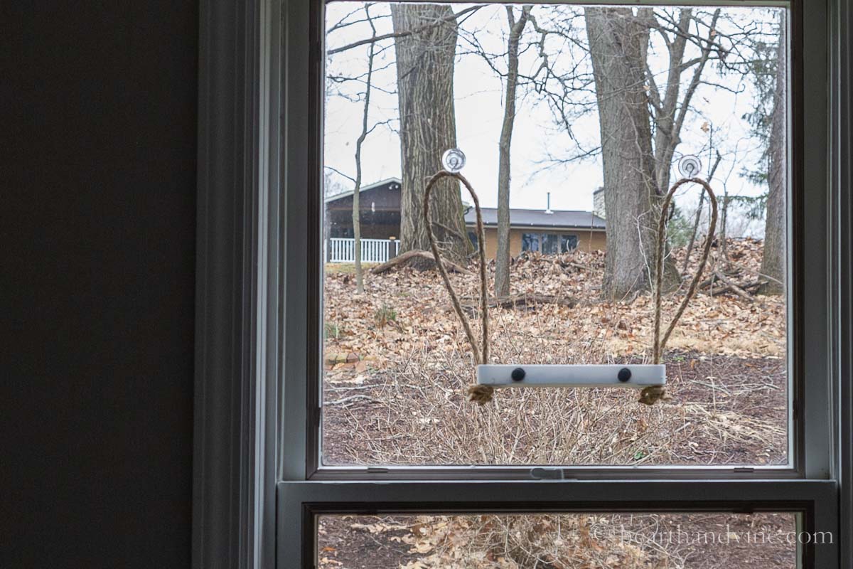 Window bird feeder with sisal rope and black velcro dots.