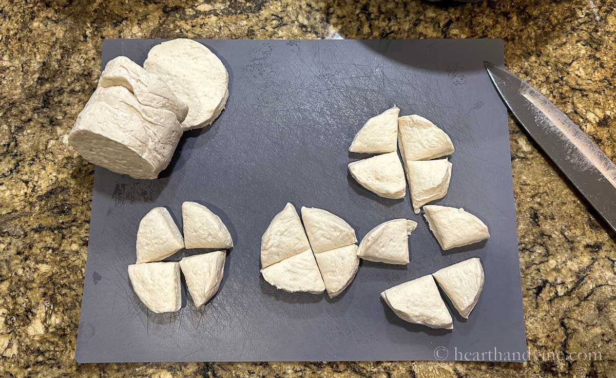 Packaged refrigerator biscuits cut into quarters.