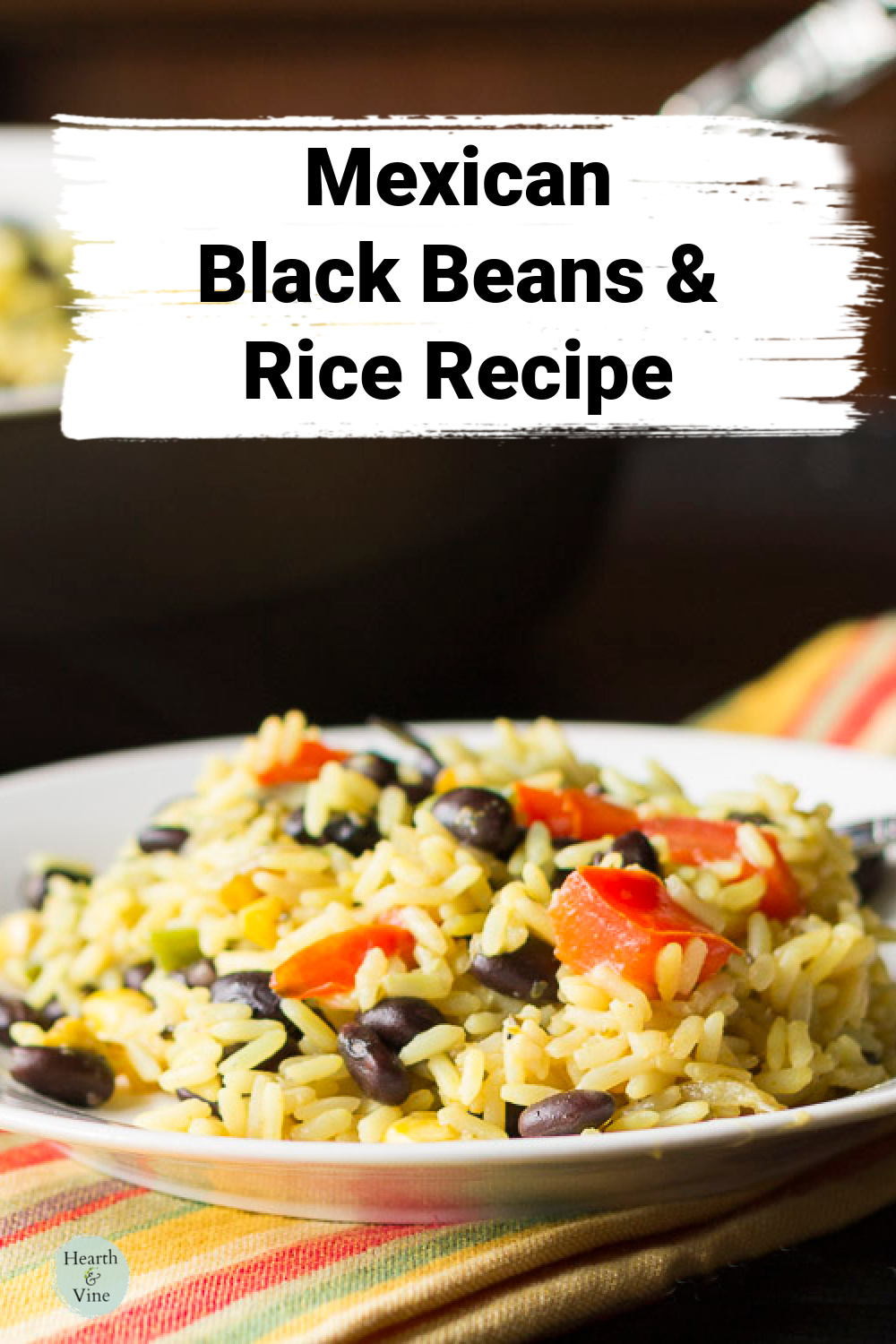 Plate of rice, black beans, peppers and tomatoes.