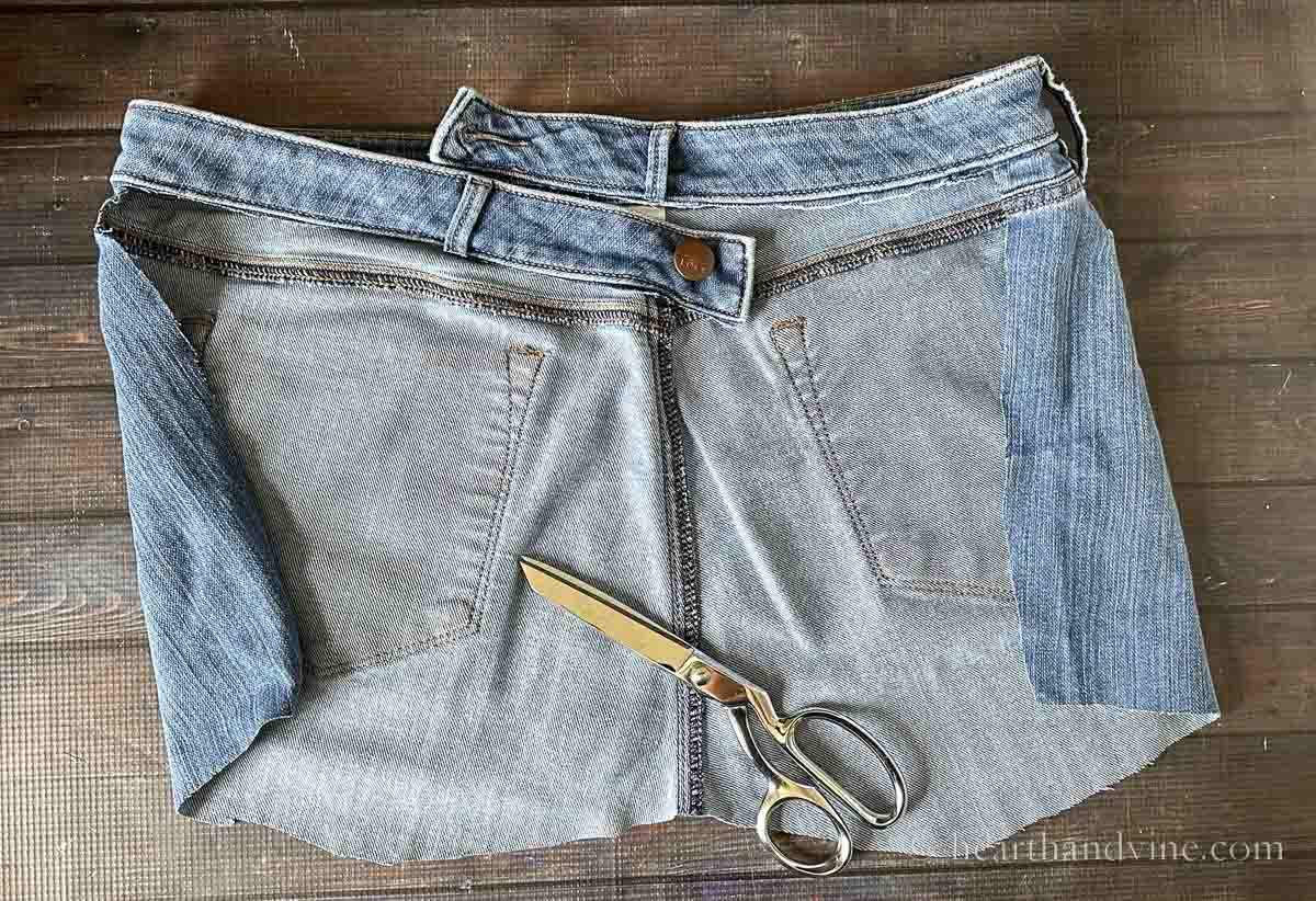 The back of a pair of jeans cut a few inches below the pockets leaving the entire waistband intact.