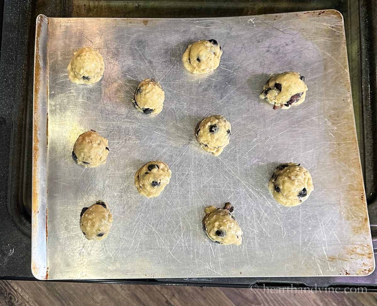 Blueberry cookie dough bowls on a cookie sheet before baking.