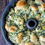Partial aerial view of spinach artichoke pull apart bread in a bundt pan.