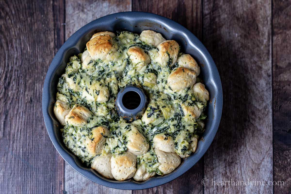 Spinach artichoke pull apart bread in a bundt pan straight from the oven.