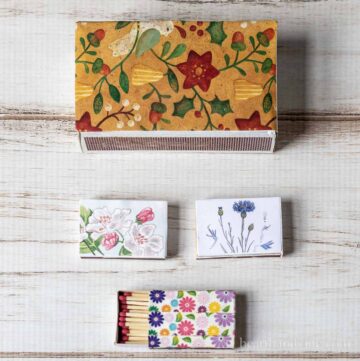 Matchboxes covers in prints. One large and three small.