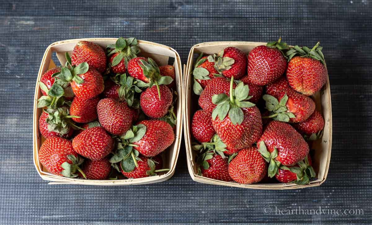 Two boxes of fresh strawberries.