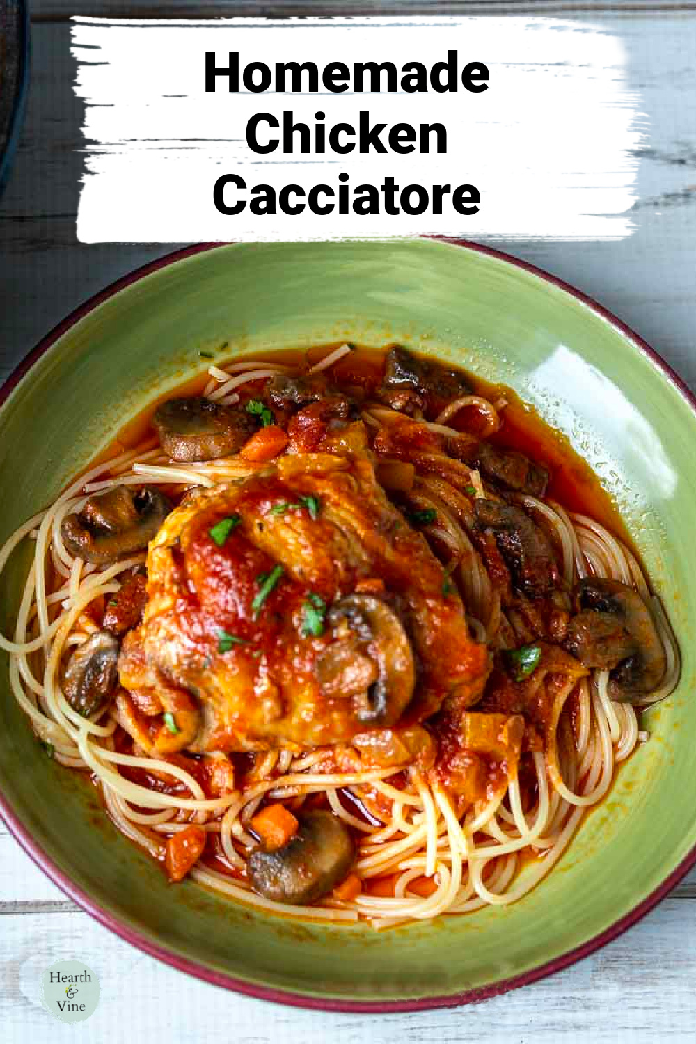 Serving bowl of chicken cacciatore over spaghetti.