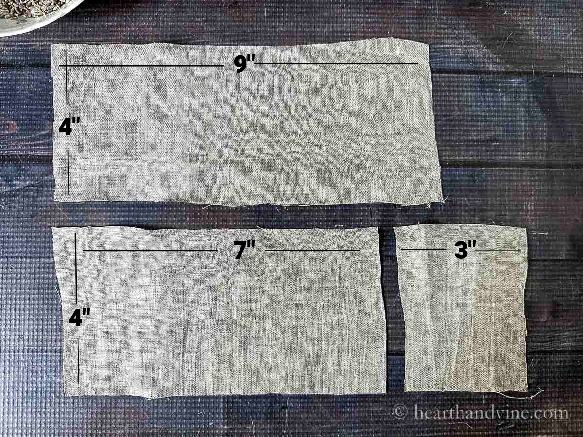 Three pieces of linen fabric marked 9" by 4" and 7" by 4" and 3" by 4".