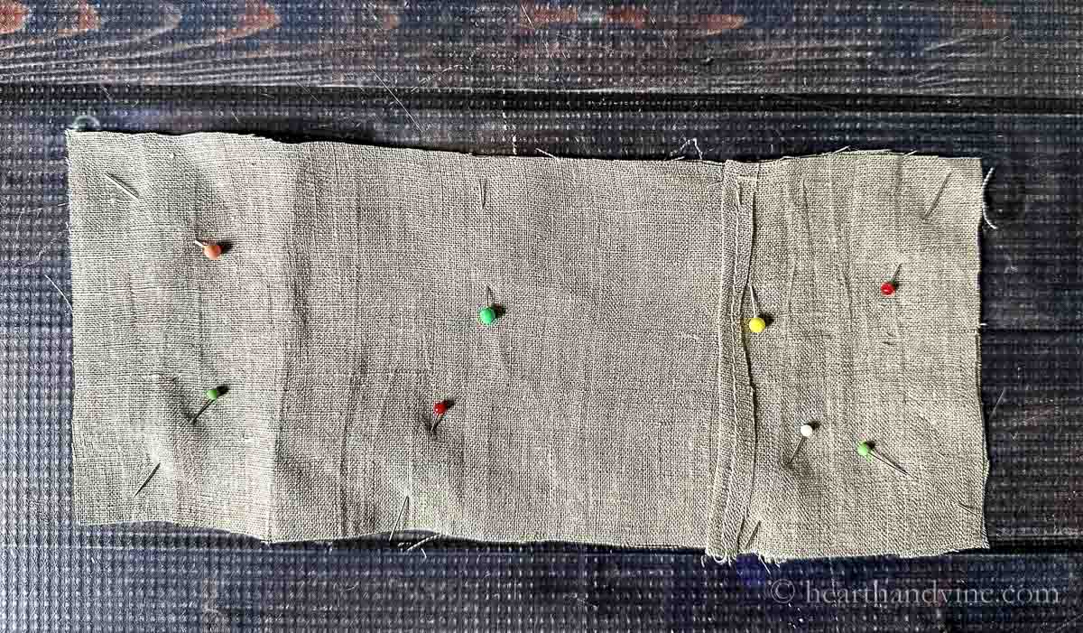 Three pieces of linen pinned together.