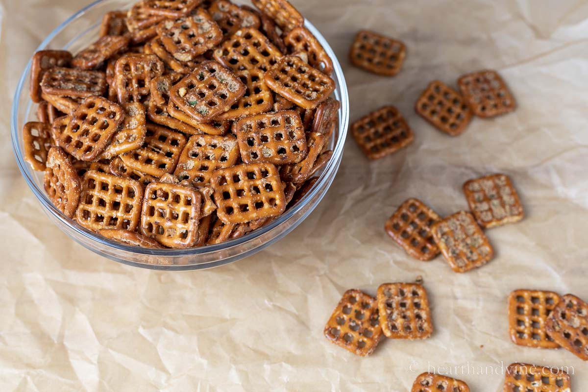 Bowl of square shaped pretzels with baked on spicy seasoning.