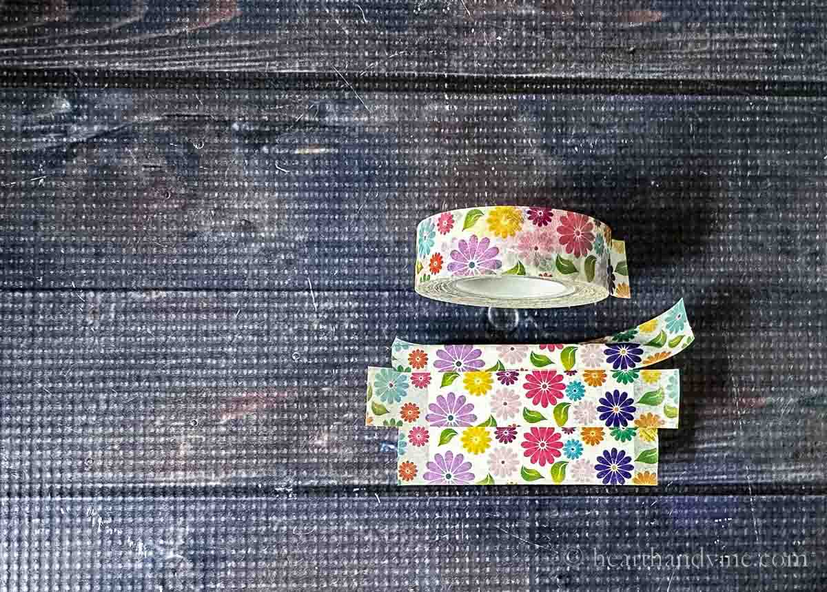 Floral washi tape roll and some covering a matchbox.