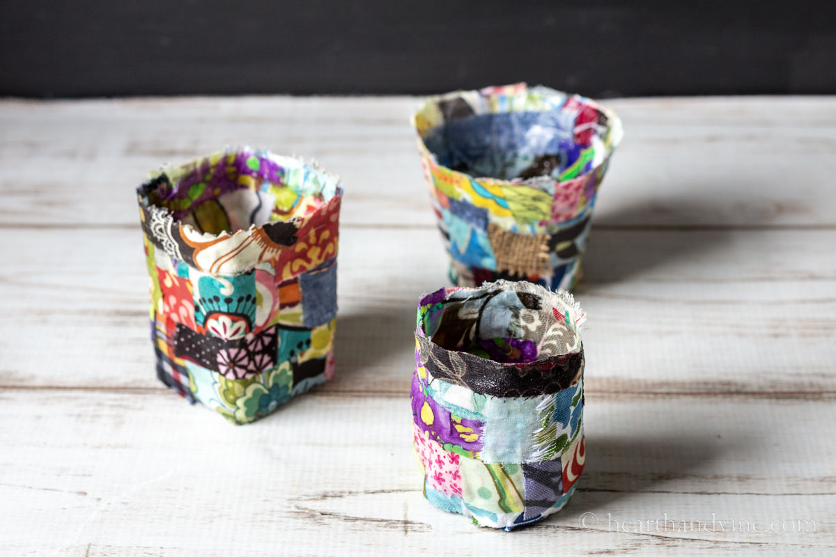 Three dried fabric pots on a table.