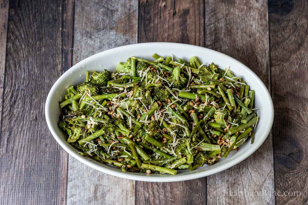 Roasted asparagus and broccoli in an oval serving dish.