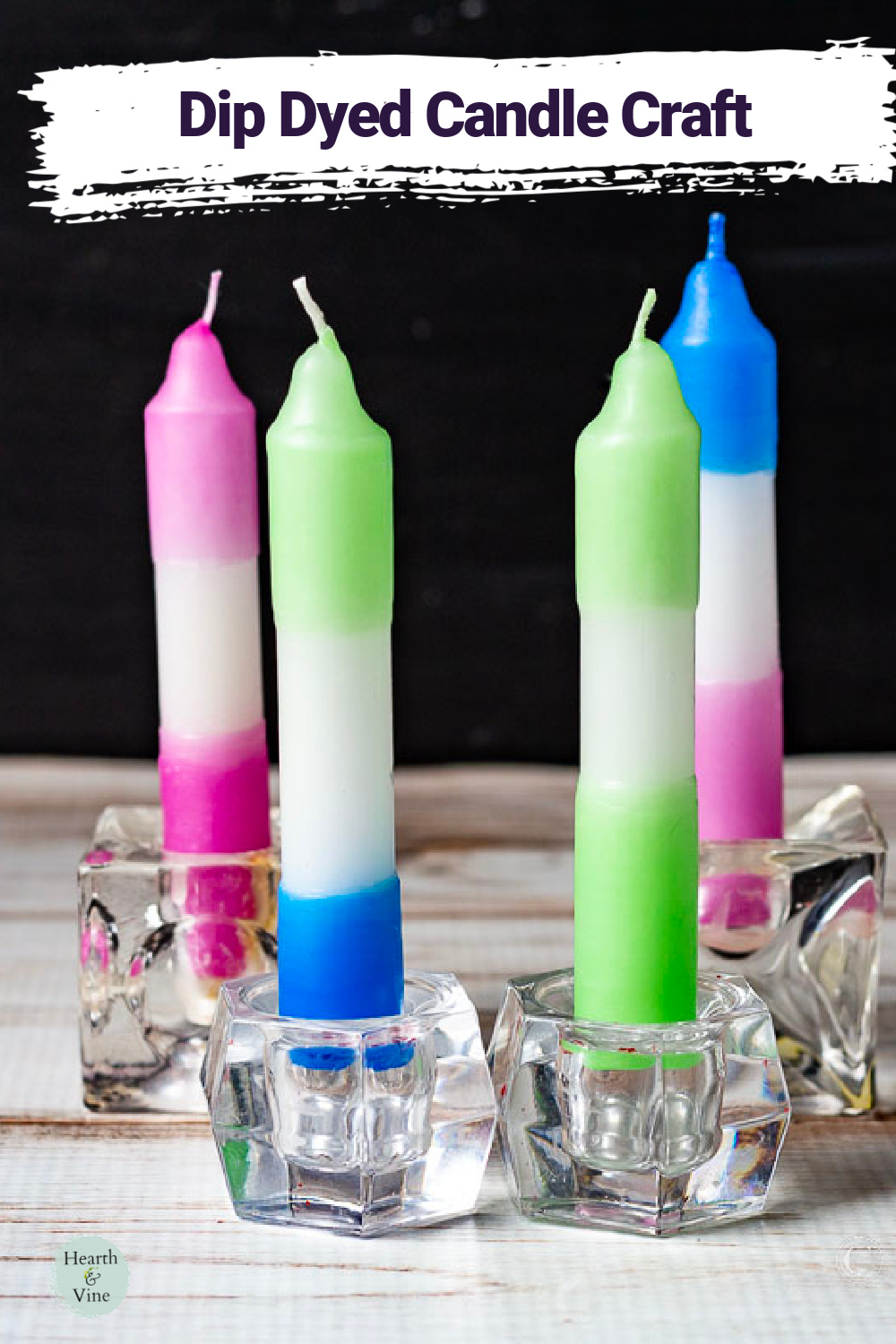 Four dipped dyed candles in small glass  holders.