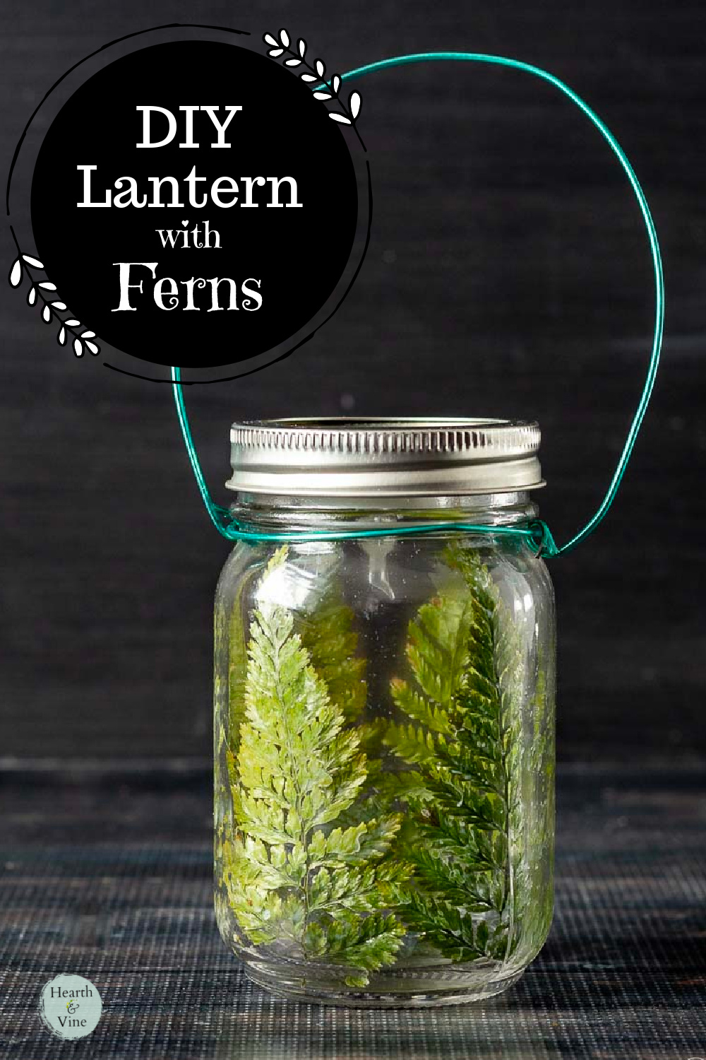 Mason jar lantern with pressed ferns and an electric tealight candle.
