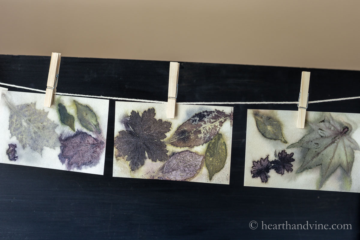 Leaf printed cards hanging on string with clothespins to dry.