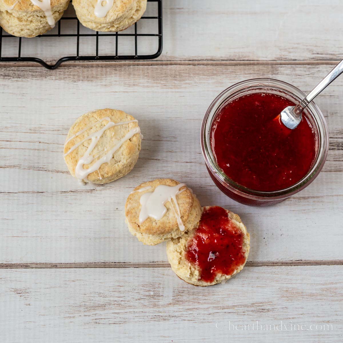 Simple scones with glaze and strawberry jam.