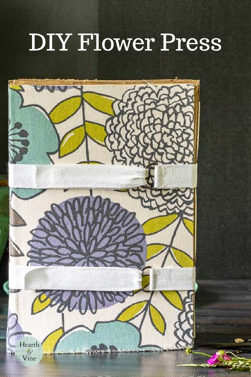 Modern floral fabric covered flower press book with canvas tape enclosure.