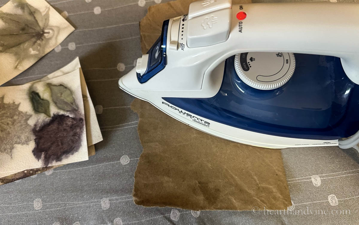 Ironing dry curled paper to flaten.