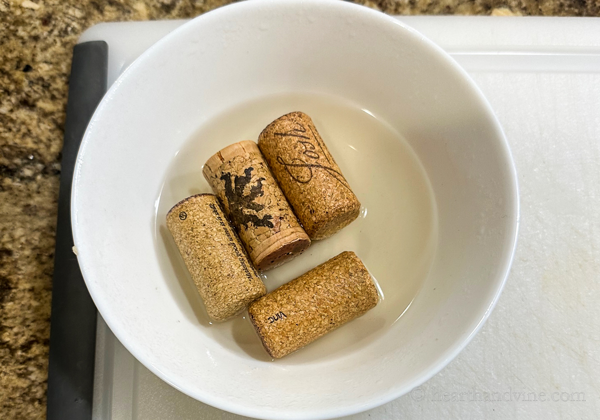 Wine corks in a bowl with water.