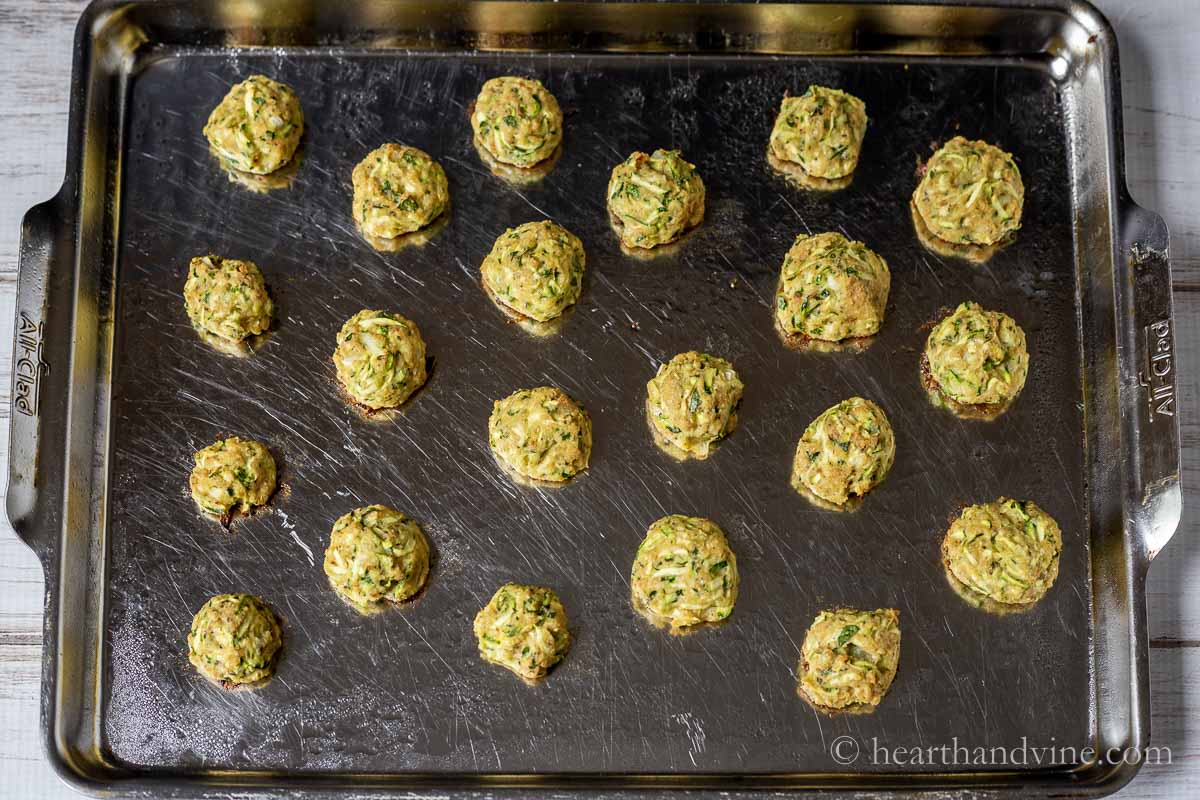 Zucchini bites on a baking dish straight from the oven.