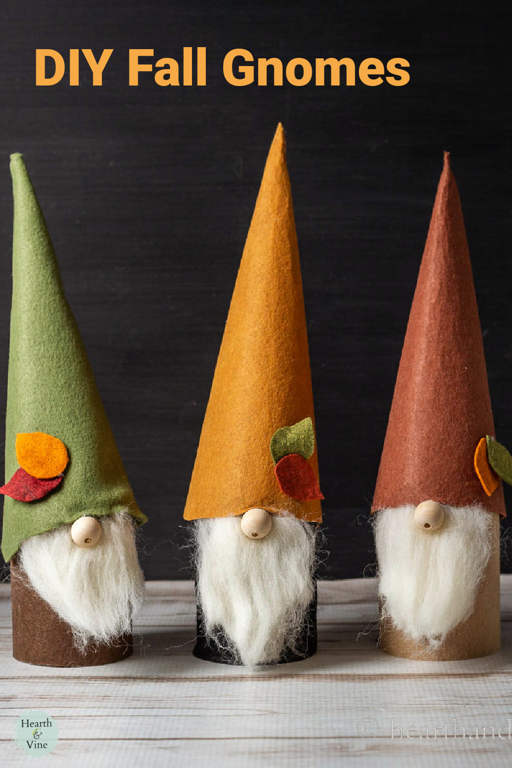 Three fall themed gnomes on a table.