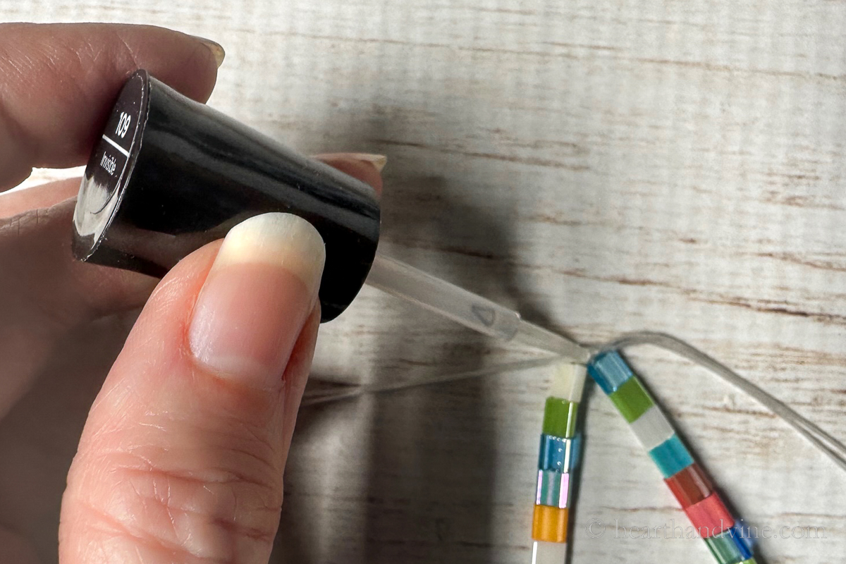 Clear nail polish placed on the knot of the stretchy bracelet cording.