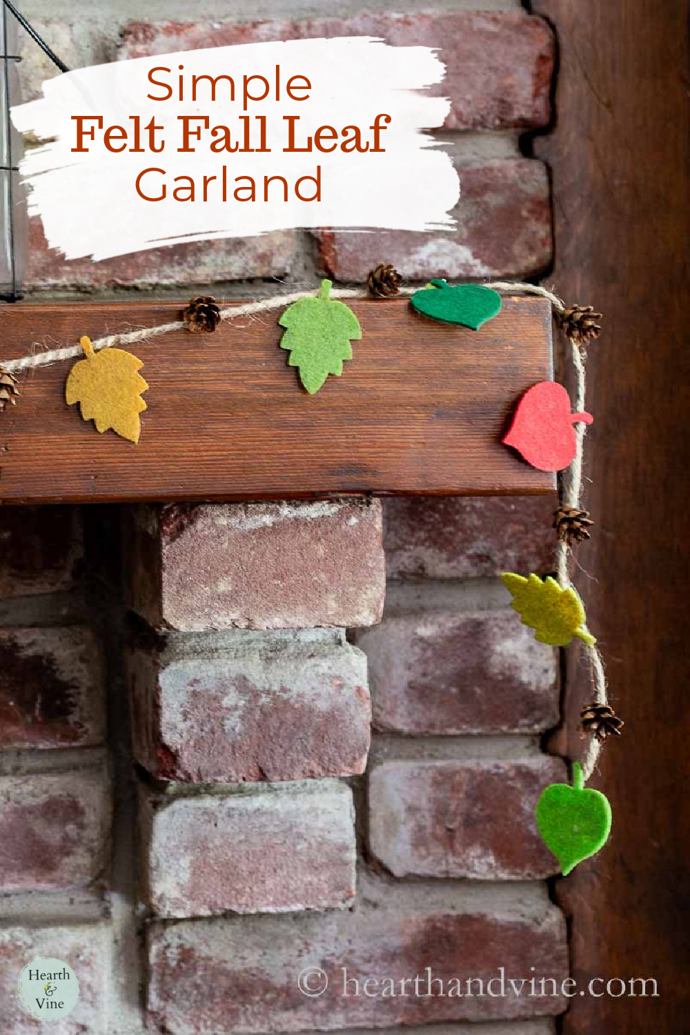 Felt leaf and pine cone garland on the corner of a mantel.