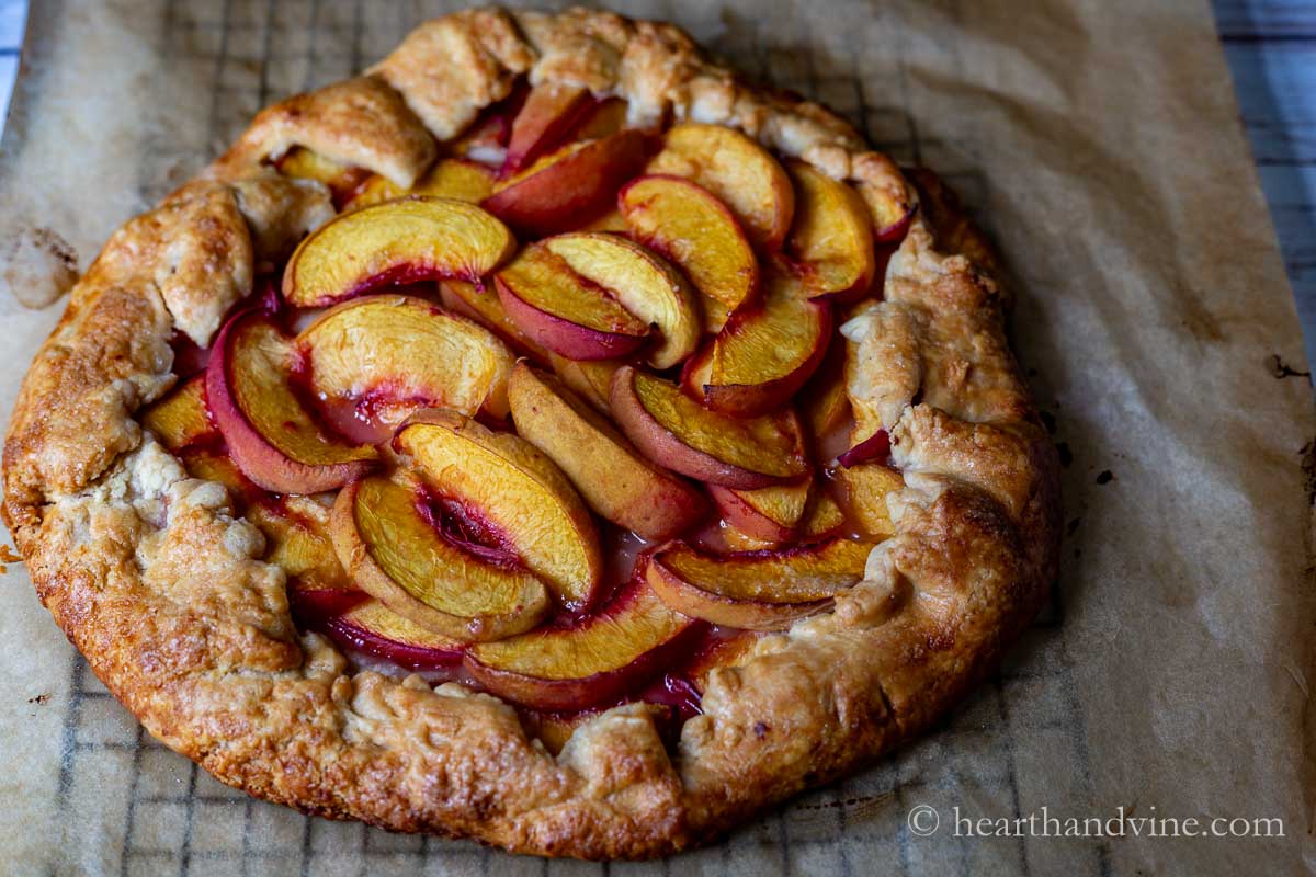 A close look at the peach crostata on a cooling rack.