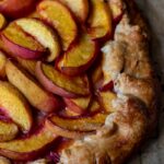 Partial view of a baked peach crostata.