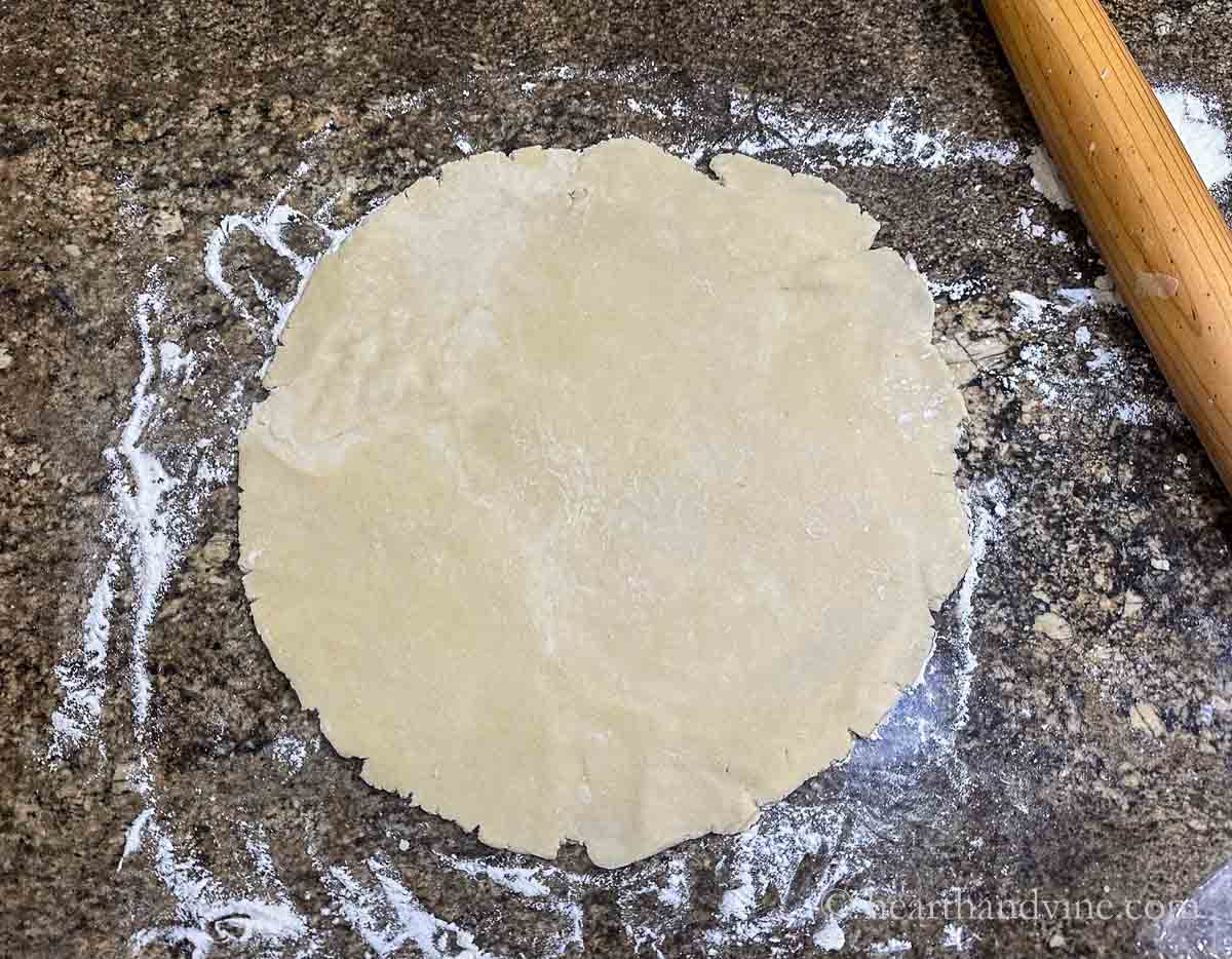 Dough rolled out into a large circle.