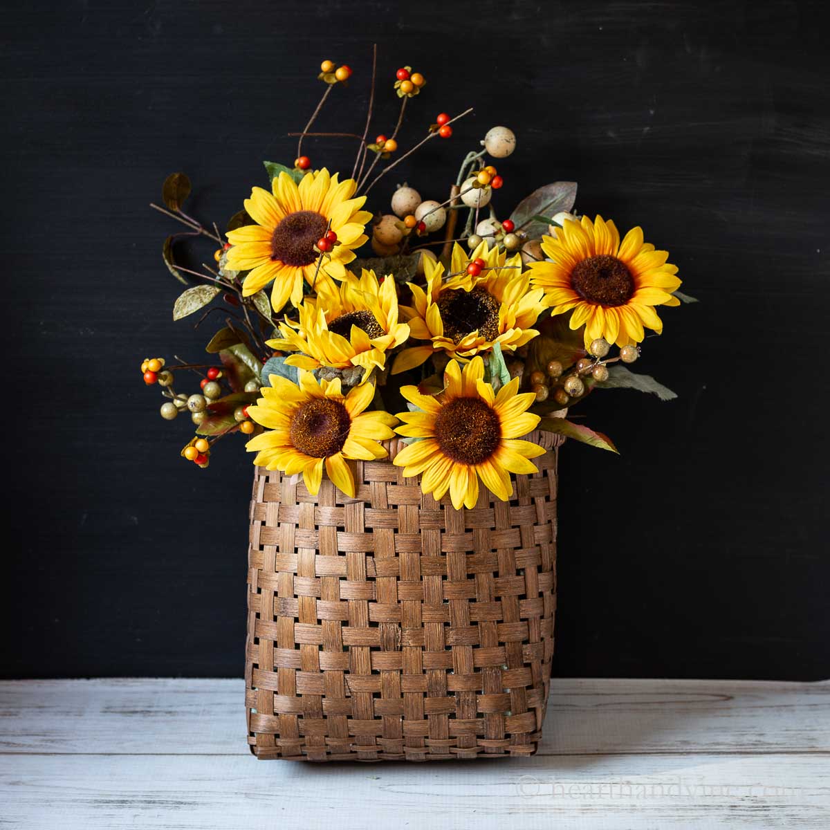 Front door basket for fall with sunflowers, bittersweet and other berries.