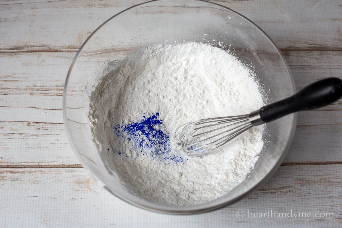 Add blue mica powder to the dry ingredients of the bath bomb recipe.
