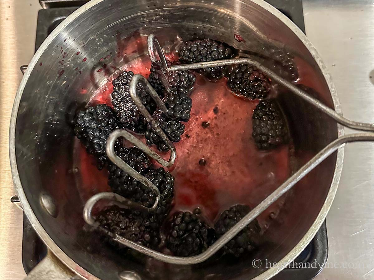 Blackberries, water and sugar reducing on the stove.