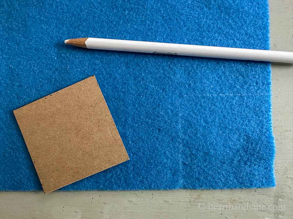 Marking pencil felt and cardboard template square.