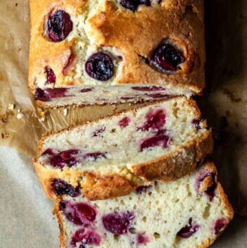 Partially sliced cherry loaf cake.