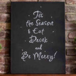 Tis the Season to Eat, Drink and Be Merry sign on canvas set on a mantel.