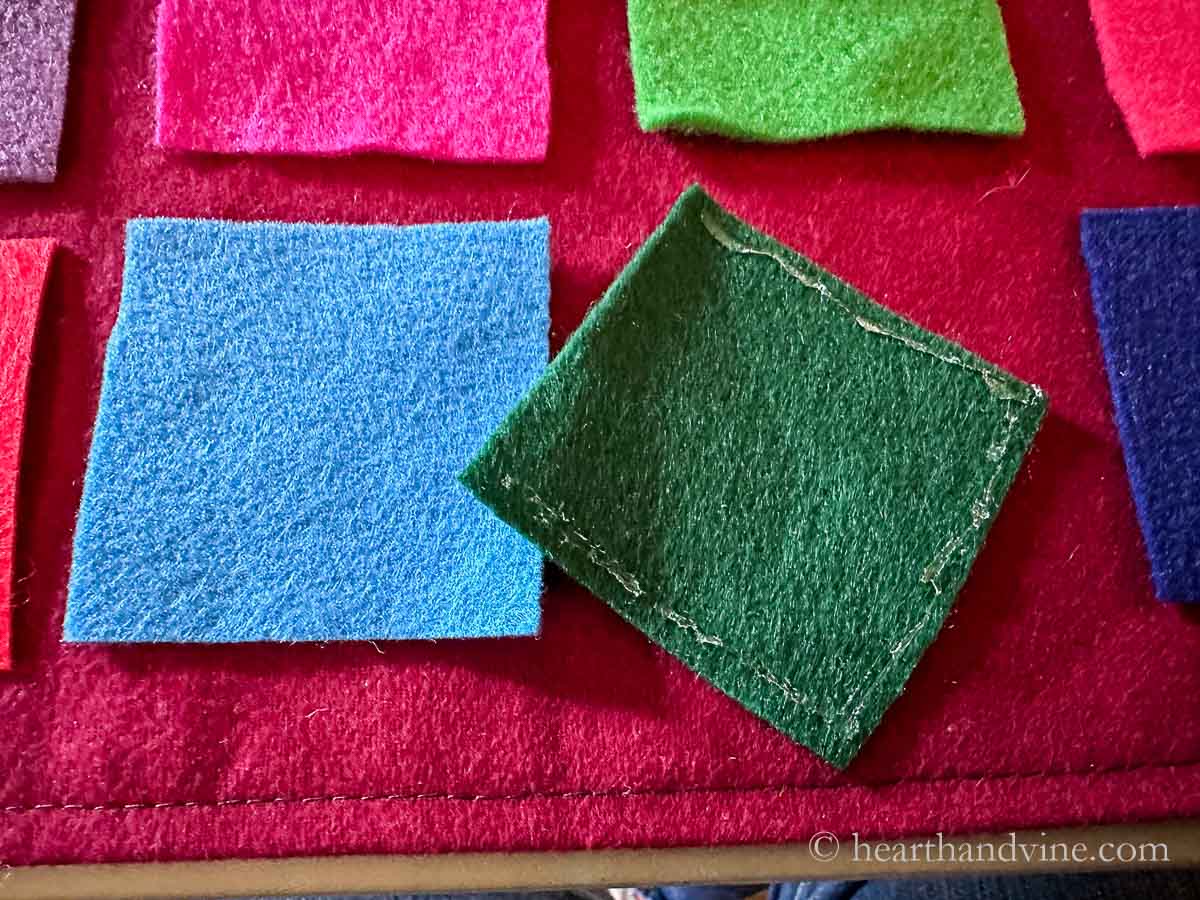 Bead of glue along the sides and bottom of a green felt square.