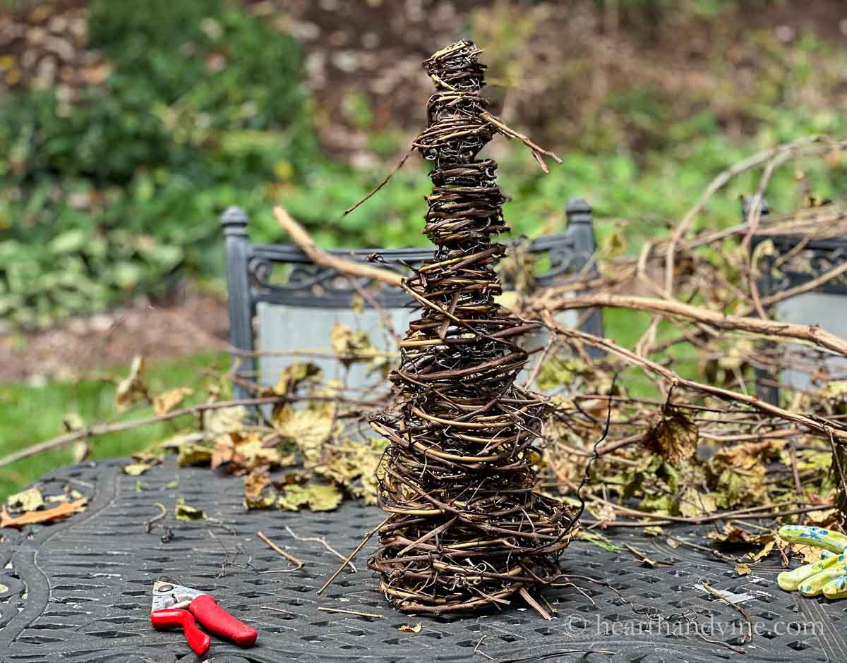 Grapevines fully wrapped around the chicken wire cone.