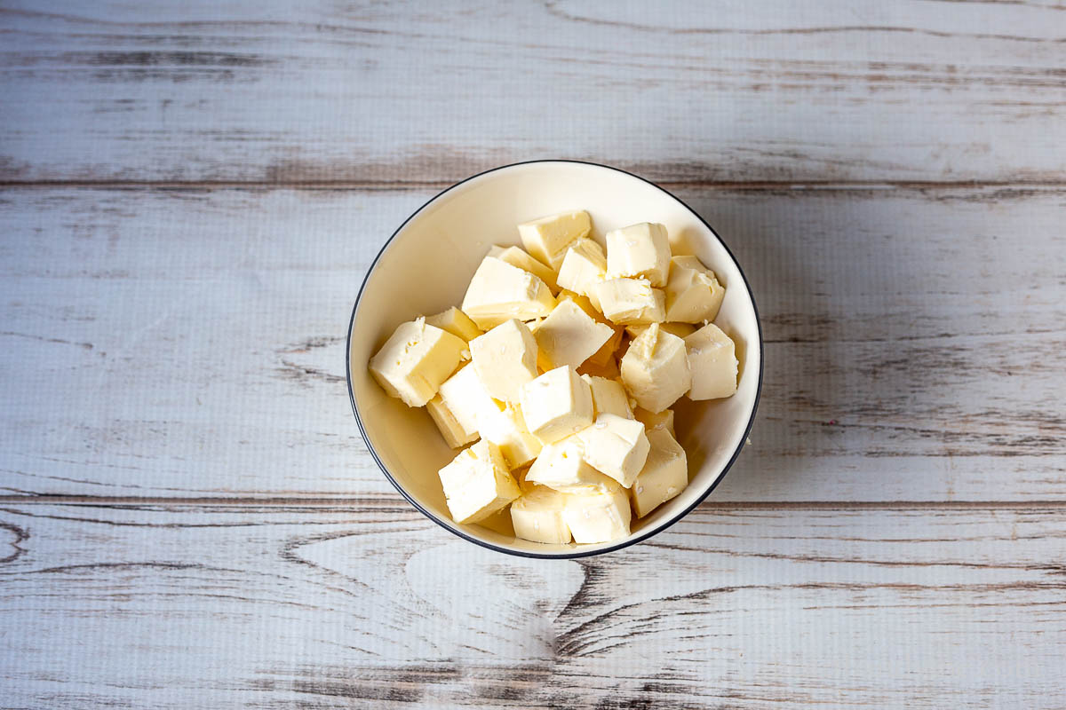 Cubes of brie cheese without the rind in a bowl.
