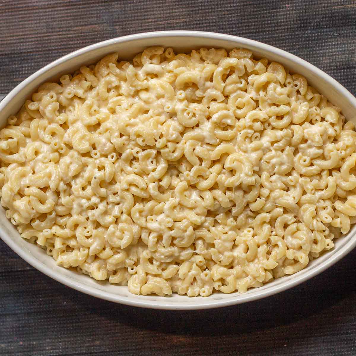 Leftover macaroni and cheese in an oval dish.